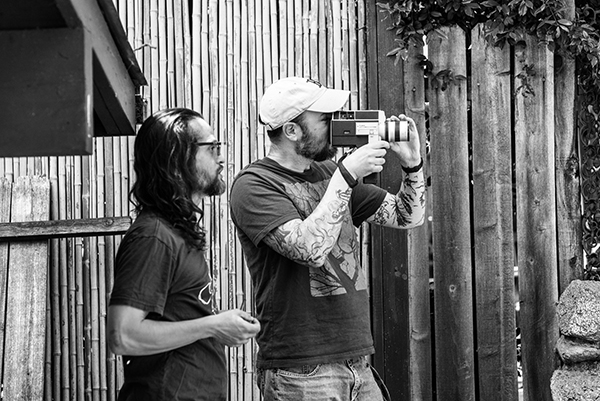 Black and
                              White photo of Greg Ansin and Michael Neel
                              shooting photography