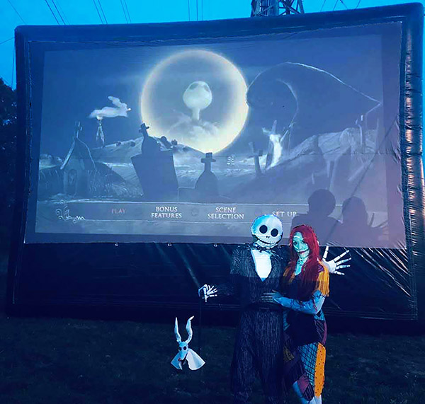 Zero, Jack, and Sally in front of The
                              Nightmare Before Christmas movie showing